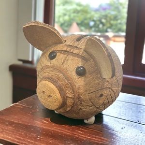 Hand carved coconut piggy bank with shell feet